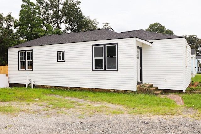 view of side of home featuring a shingled roof