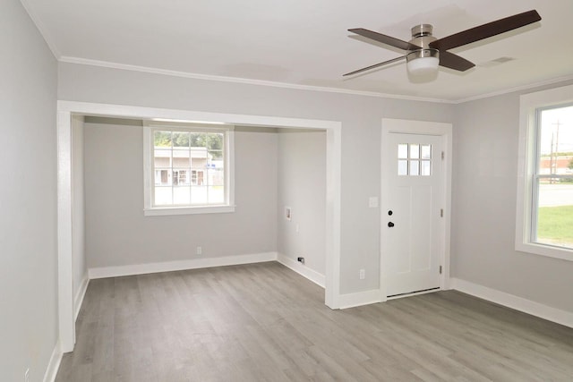 entrance foyer featuring crown molding, visible vents, a ceiling fan, wood finished floors, and baseboards