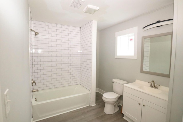 bathroom with bathtub / shower combination, visible vents, toilet, vanity, and wood finished floors