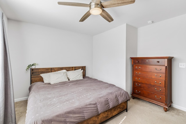 bedroom with baseboards, a ceiling fan, and light colored carpet