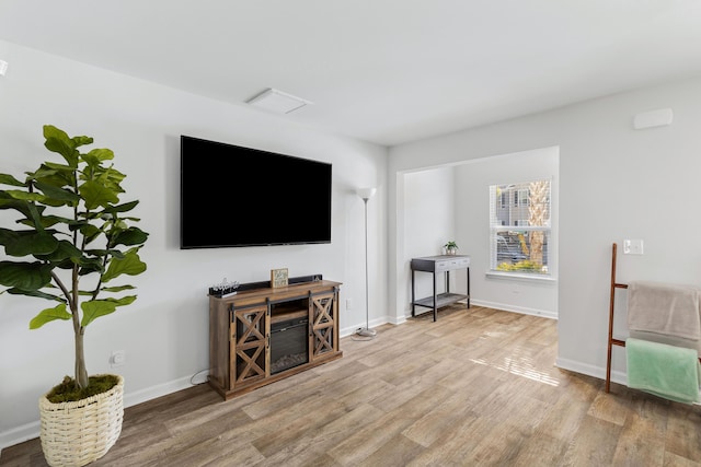 living room with light wood finished floors and baseboards