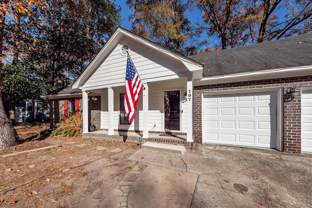 view of front of property with a porch and a garage