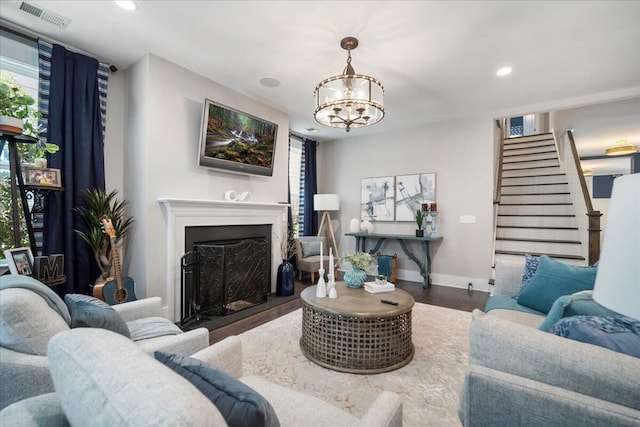 living room featuring hardwood / wood-style flooring and an inviting chandelier