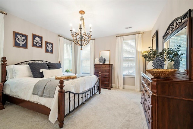 carpeted bedroom with a chandelier