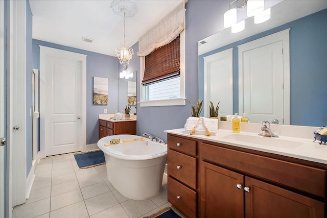 bathroom featuring a tub, vanity, a chandelier, and tile patterned flooring