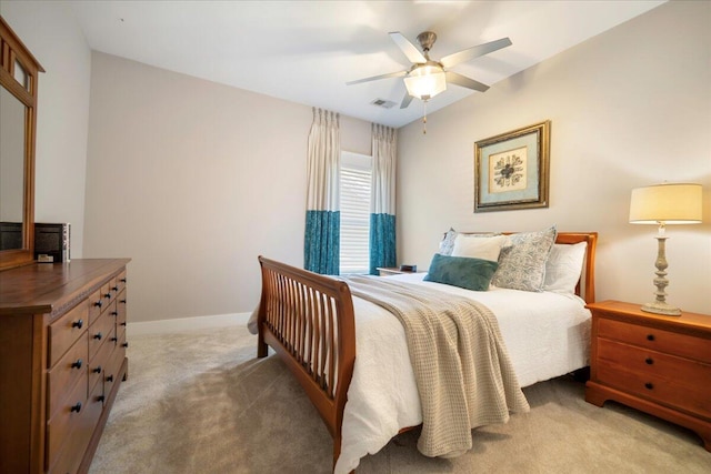 bedroom with ceiling fan and light colored carpet