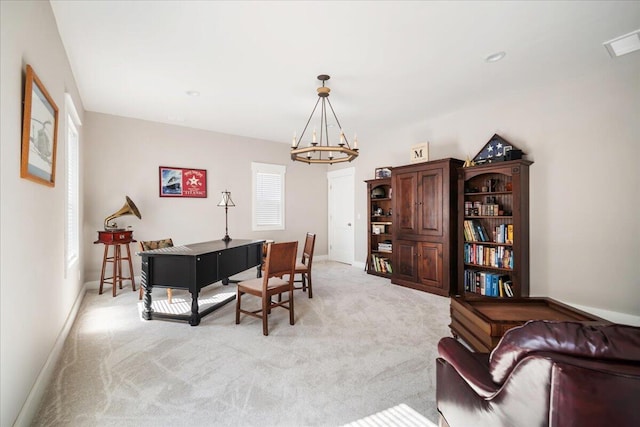 carpeted home office with a chandelier