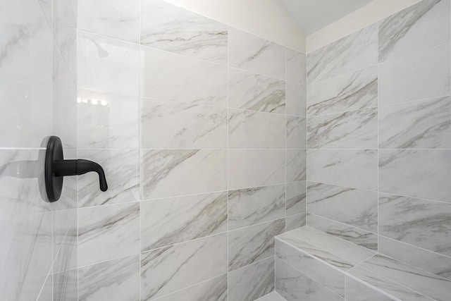 interior details featuring tiled shower