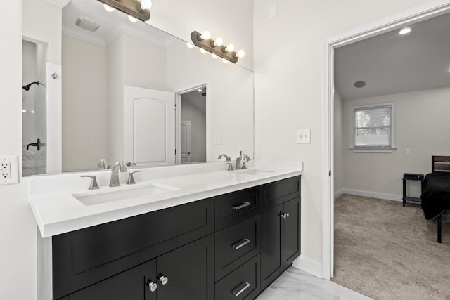 full bathroom with double vanity, ornamental molding, a sink, and baseboards