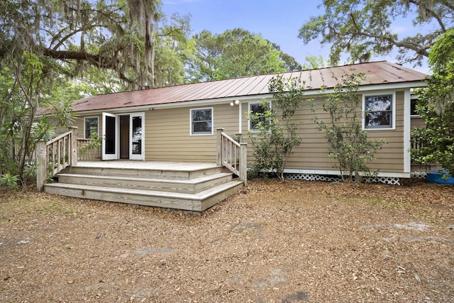 rear view of house featuring metal roof