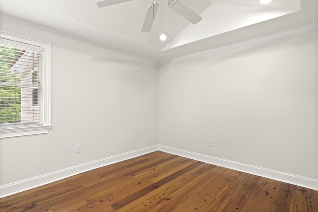 empty room with dark wood-type flooring, vaulted ceiling, baseboards, and ceiling fan