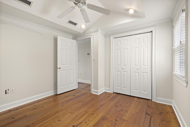 unfurnished bedroom featuring wood-type flooring, visible vents, and baseboards