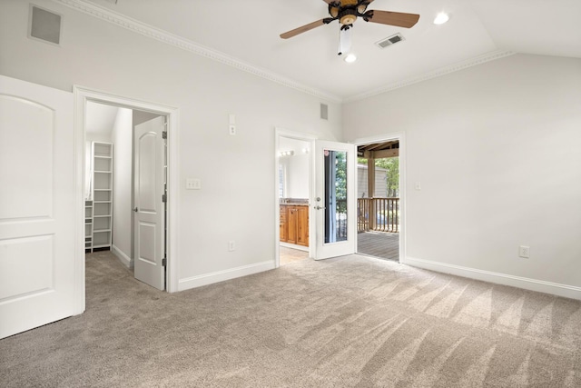 unfurnished bedroom featuring carpet floors, baseboards, a spacious closet, and visible vents