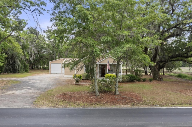 obstructed view of property featuring aphalt driveway and a garage