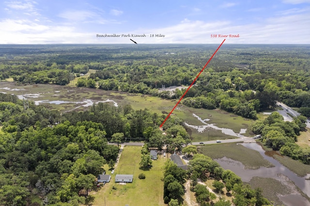 bird's eye view featuring a wooded view