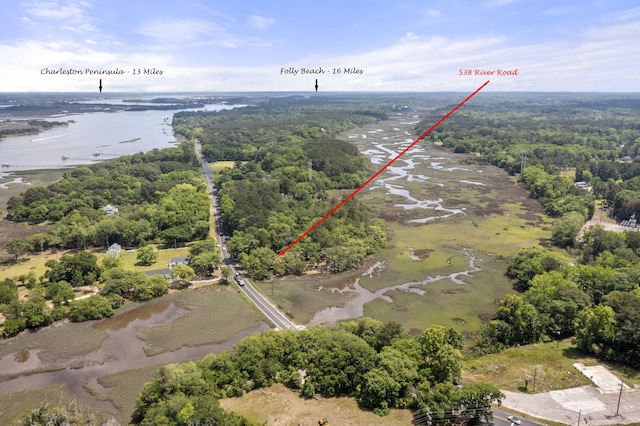 birds eye view of property with a forest view and a water view