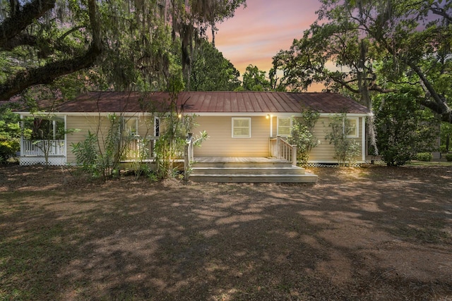 rear view of house featuring metal roof