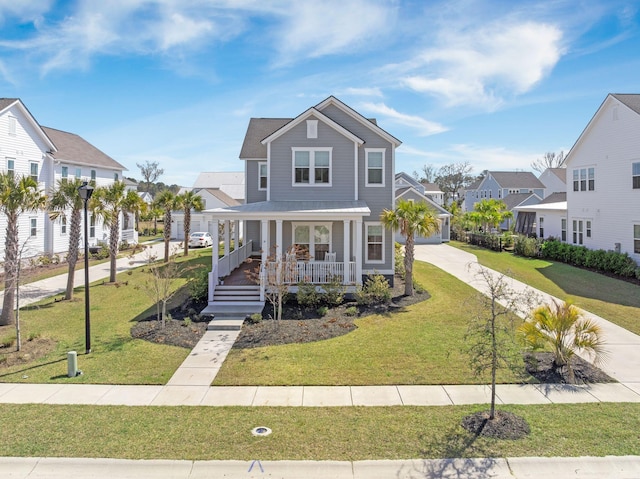 view of front of house featuring a residential view, covered porch, concrete driveway, and a front yard