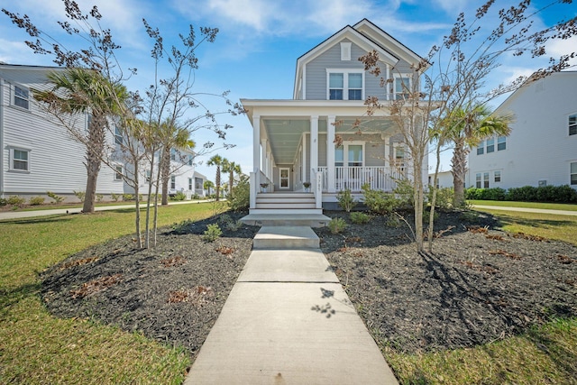 view of front of property with a porch and a front lawn