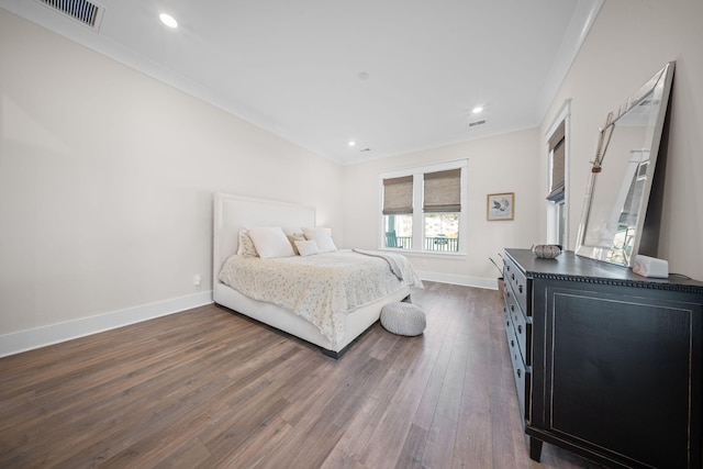 bedroom featuring visible vents, dark wood-type flooring, ornamental molding, recessed lighting, and baseboards