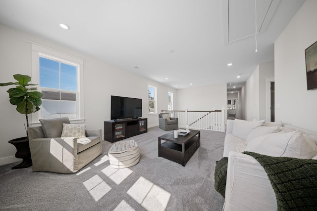 carpeted living room with recessed lighting, attic access, and baseboards