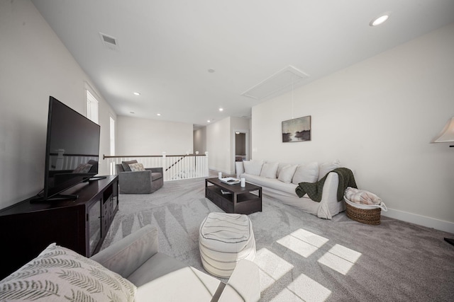 carpeted living area featuring attic access, recessed lighting, baseboards, and visible vents