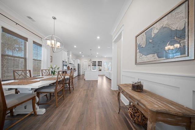 dining area with visible vents, crown molding, dark wood-type flooring, recessed lighting, and a notable chandelier