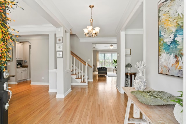3526 Stockton Dr, Mount Pleasant, SC 29466 - foyer entrance with baseboards, light wood-type flooring, crown molding, stairs, and ceiling fan with notable chandelier