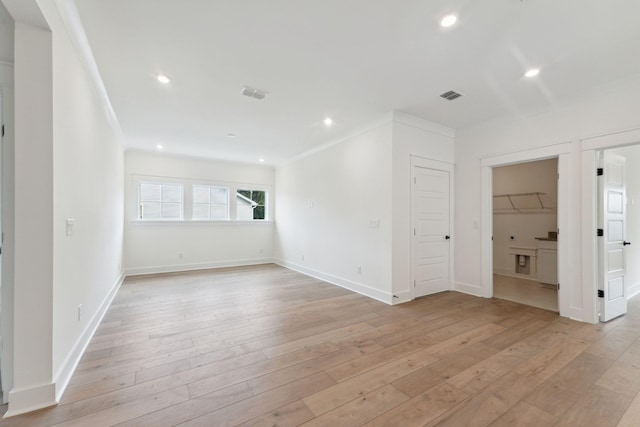 spare room with light hardwood / wood-style flooring and ornamental molding