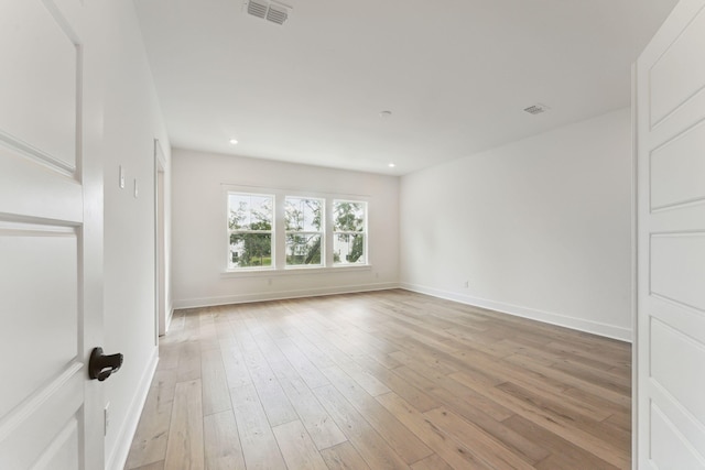 spare room featuring light hardwood / wood-style floors