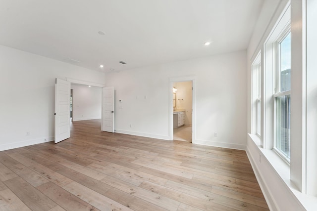 empty room featuring light wood-type flooring and a wealth of natural light