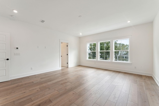 spare room with light hardwood / wood-style flooring