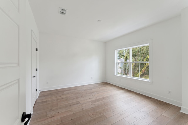 spare room featuring light wood-type flooring