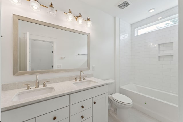 full bathroom with tile patterned flooring, vanity, toilet, and tiled shower / bath combo