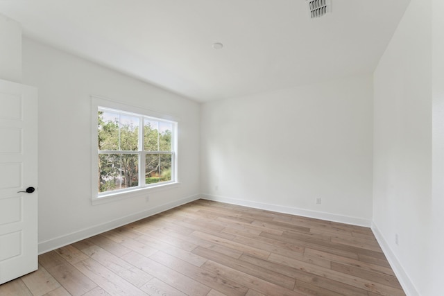 empty room with light hardwood / wood-style flooring