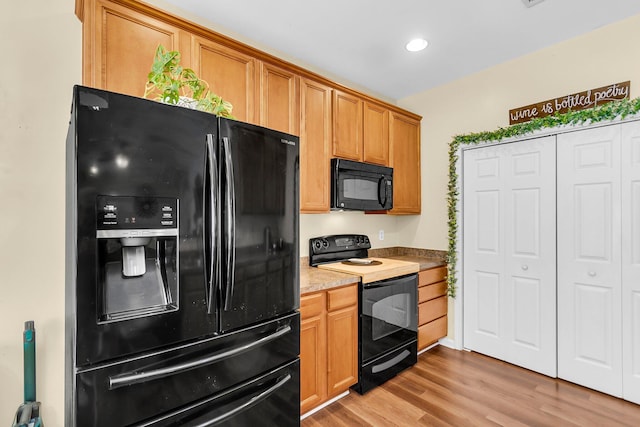 252 Island Green Rd, Goose Creek, SC 29445 - kitchen with black appliances, light wood-style floors, recessed lighting, and brown cabinetry