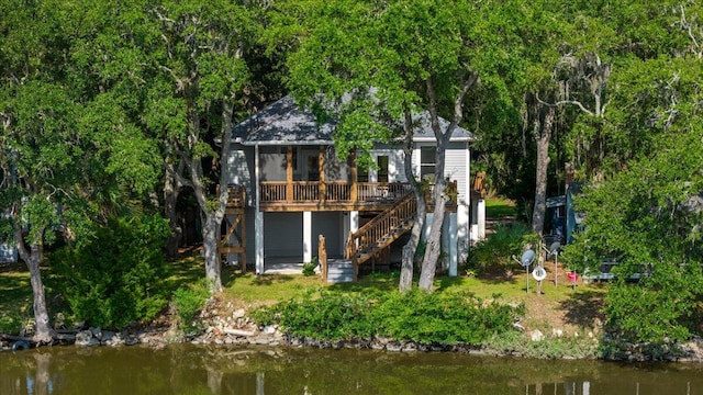 rear view of house with a deck with water view