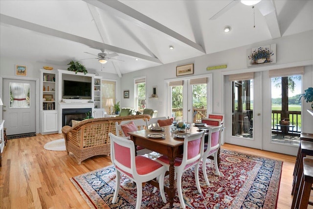 dining room with light wood-type flooring, french doors, beamed ceiling, and high vaulted ceiling