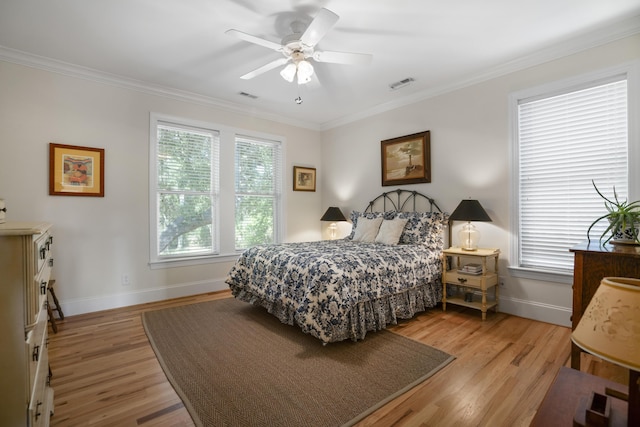 bedroom featuring light wood-type flooring, ceiling fan, and ornamental molding