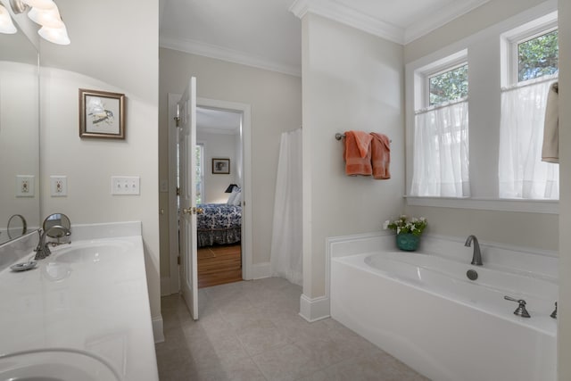 bathroom with a bathing tub, vanity, tile patterned floors, and ornamental molding