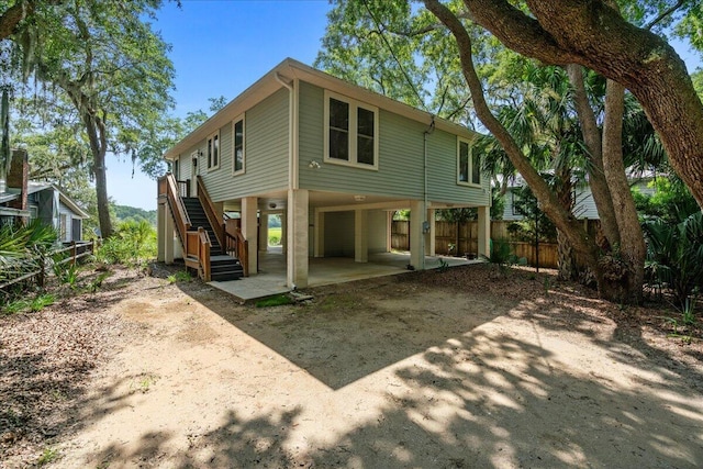 back of house featuring a carport