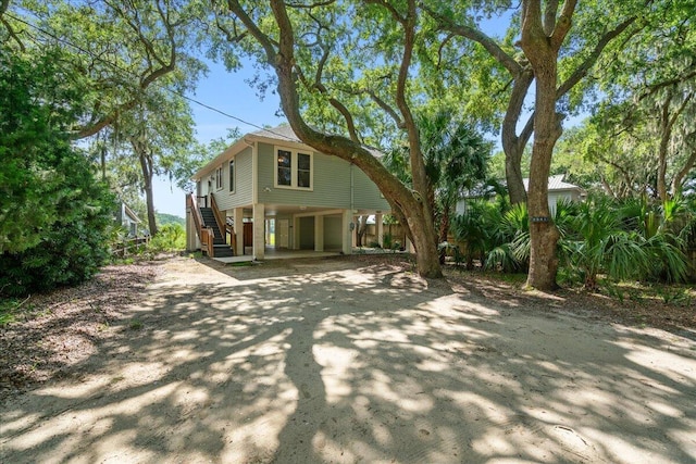 back of property featuring a garage and a carport