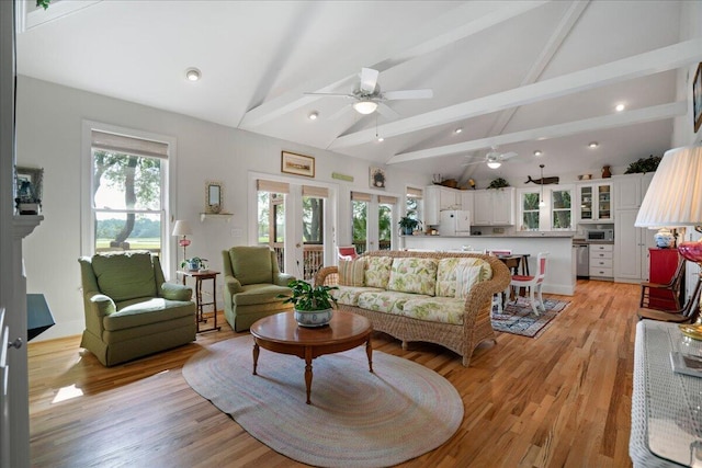 living room featuring light hardwood / wood-style floors, high vaulted ceiling, beam ceiling, and ceiling fan