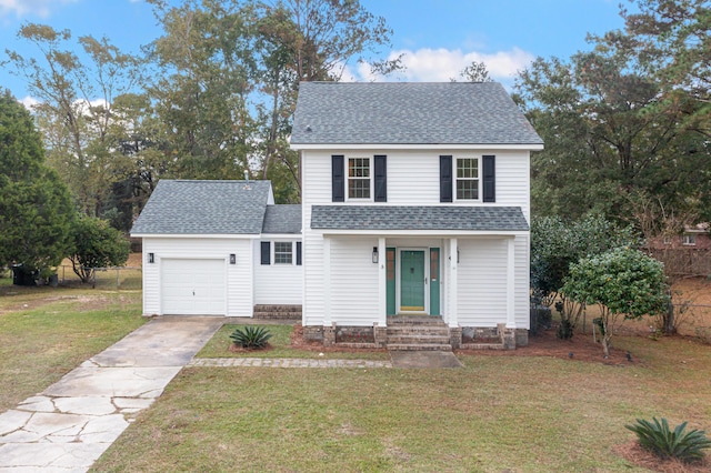 traditional-style home with concrete driveway, roof with shingles, a front yard, a garage, and fence