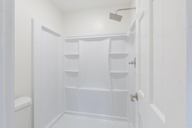 full bath featuring toilet and a shower