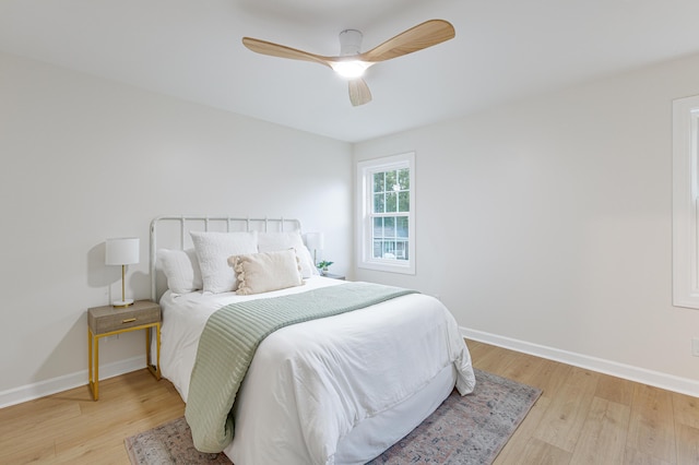 bedroom featuring light wood-style flooring, ceiling fan, and baseboards