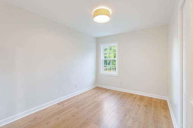 unfurnished room featuring light wood finished floors and baseboards