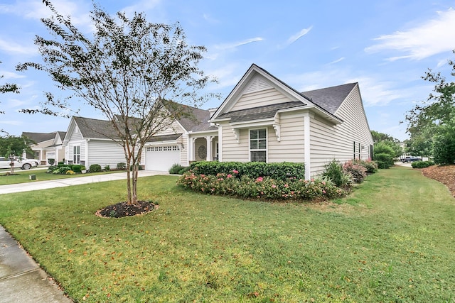 view of front property with a front lawn and a garage