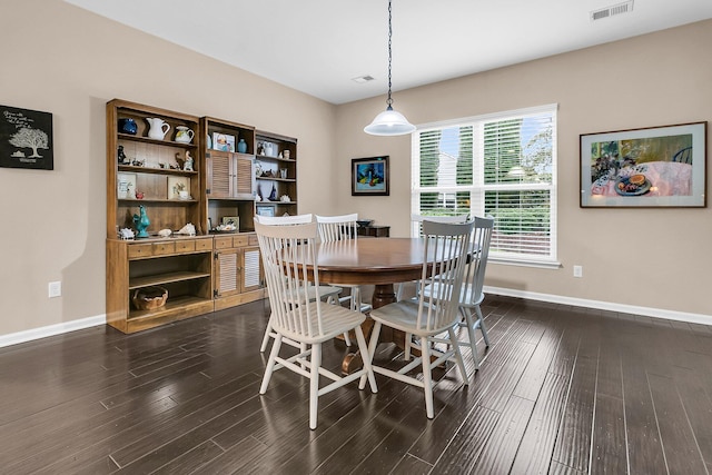 dining space featuring dark hardwood / wood-style floors