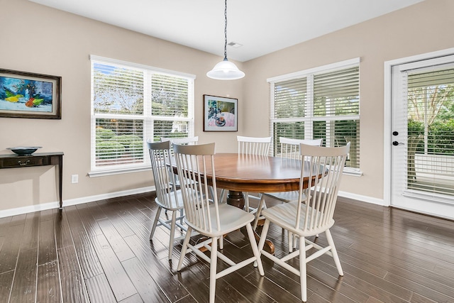 dining area featuring dark wood-type flooring